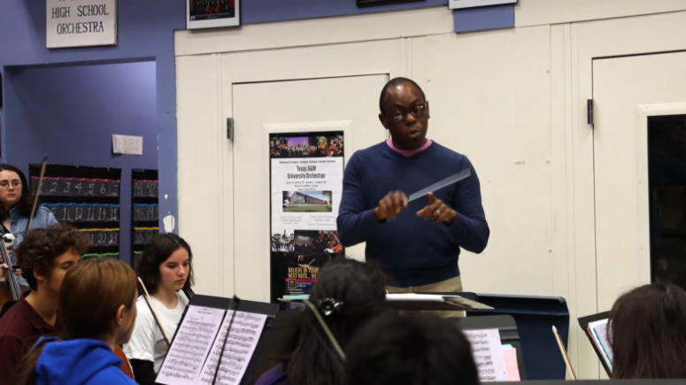 Music orchestra conductor teaching students