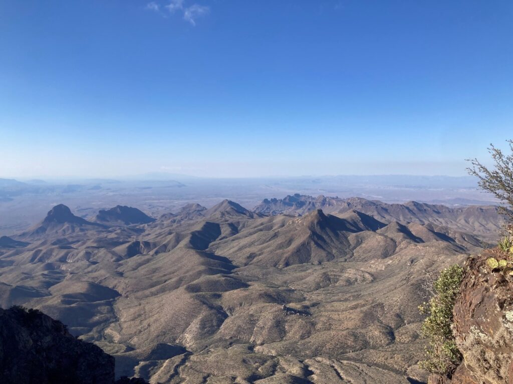 Sweeping view of mountainous terrain and blue sky seen from the south rim in Big Bend National Park.
