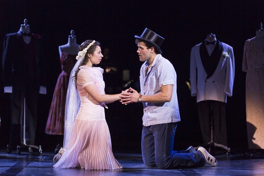 performers kneeling on stage