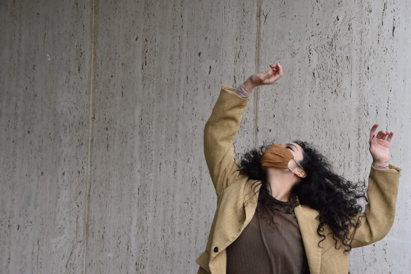 woman dancing against a wall