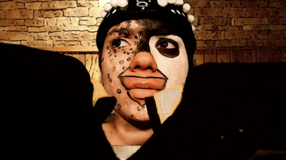 man in face paint with black and white markings on his face