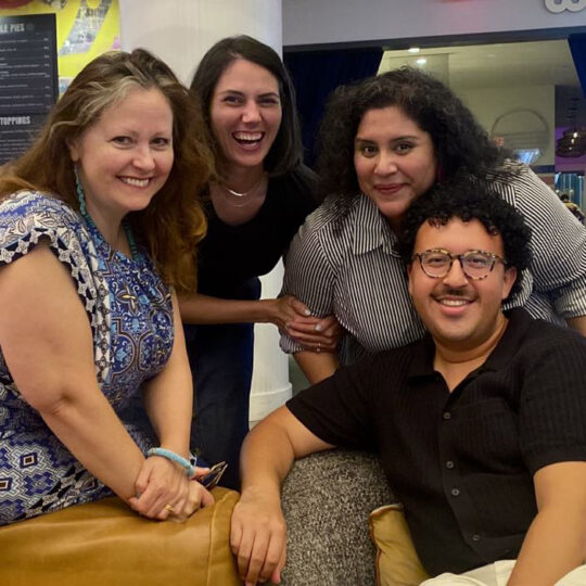 Two faculty members, a current student and an alum pose together at the Association for Theatre in Higher Education Conference