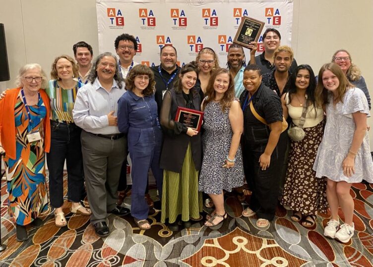 A group of alumni, students, faculty and former faculty posing together while attending the American Alliance for Theatre and Education