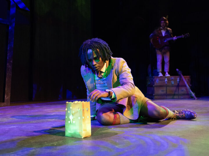 A scene from JAMES AND THE GIANT PEACH in which James looks inquisitively at a bag of glowing green magical items