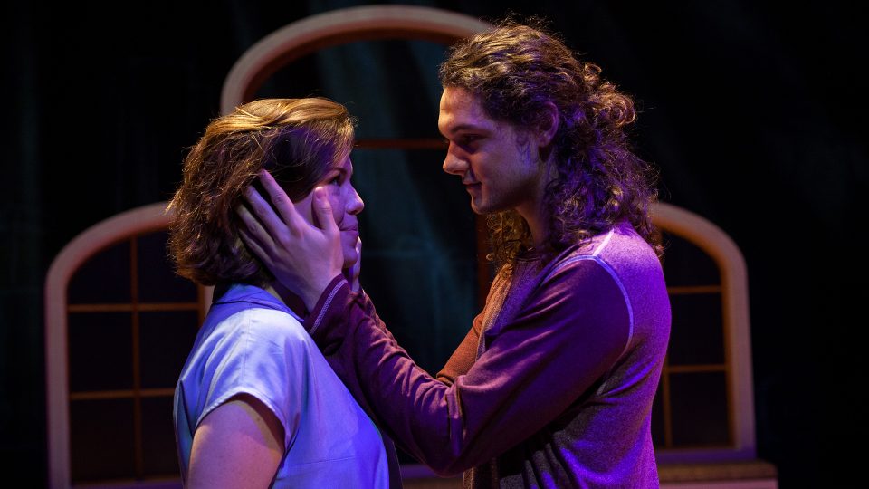 man with hands on womans face