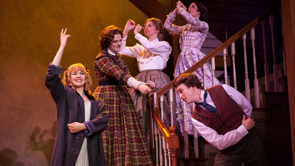cast of little women standing on stairs
