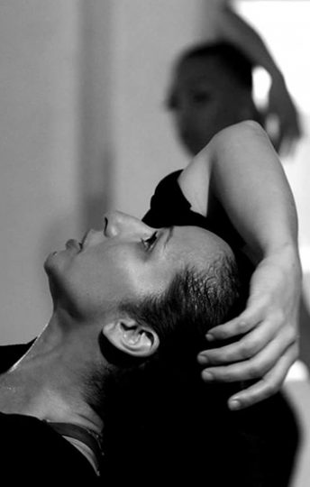 woman leaning back posing with her hand on her head