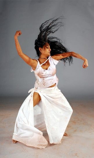 dancing woman in white outfit posing