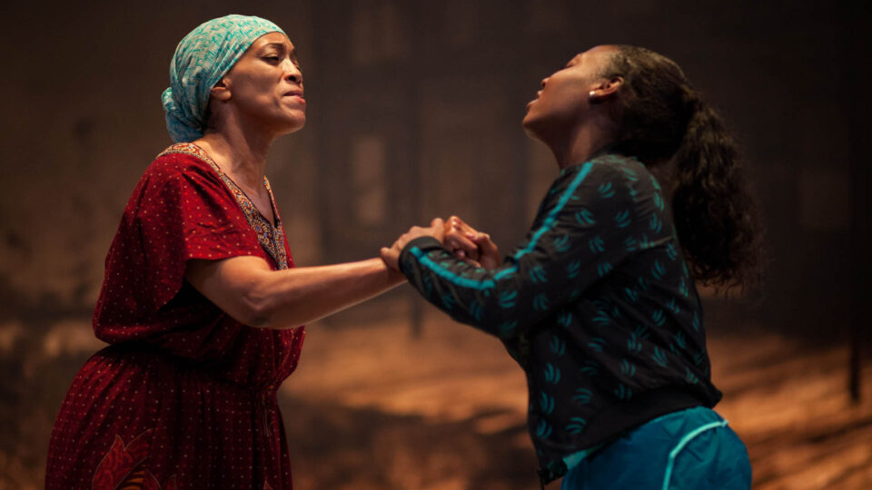 image from red and brown water of oya holding hands
