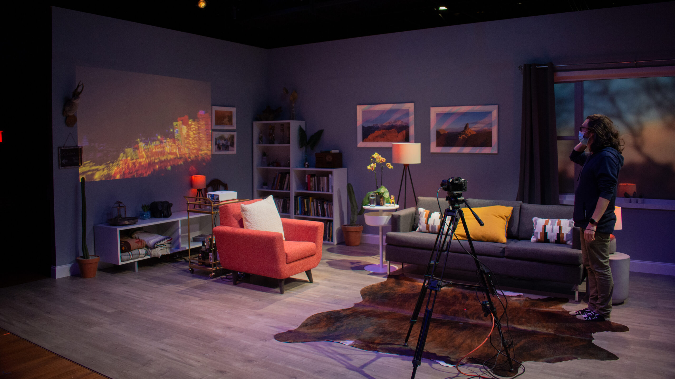 man standing on empty set of a living room