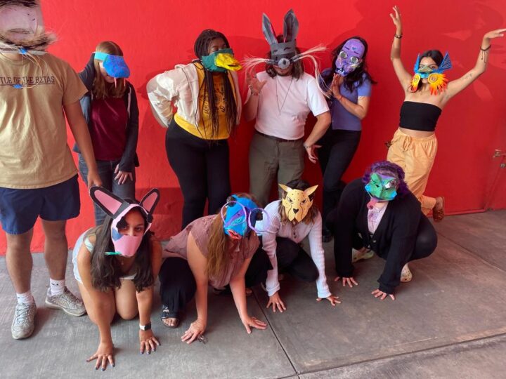 Students and professor in masks created in workshop with Daniel Loyola