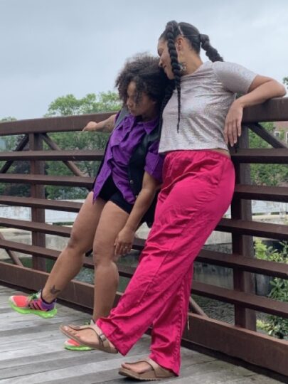 Photo of Love Muwwakkil and Yunina Barbour-Payne leaning against a bridge
