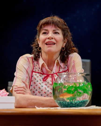 Photo of Barbara Chisholm as Ernestine in an apron 