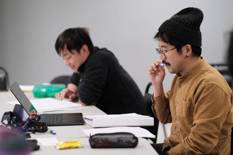 Playwright Chih-Ching Chester Tsai and an actor read from their scripts during a read-through of A TALE FOR HOME