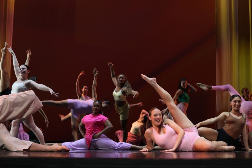 Dancers strike various poses at the end of the dance piece "How to Watch a Dance Repertory Theatre Concert"
