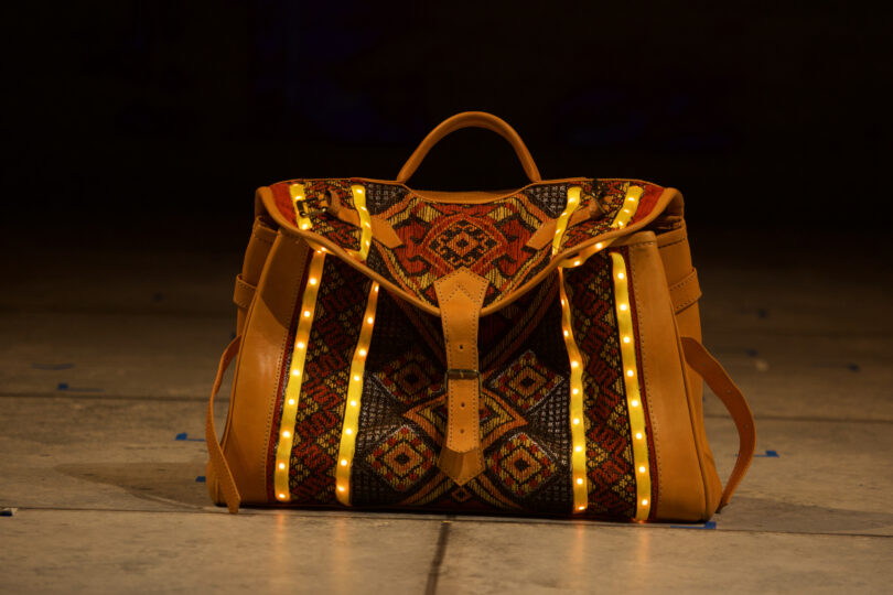 A colorful bag with LED lights lining the outside sits on stage