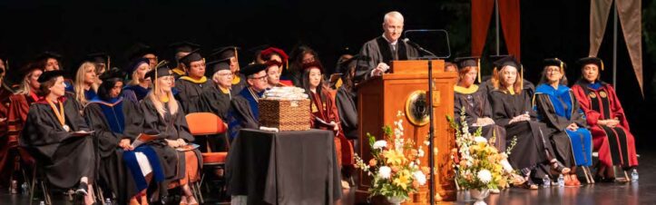 stage with commencement participants