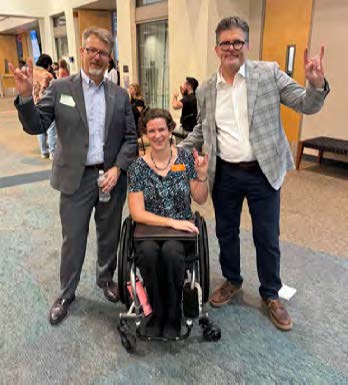 Dean Cole poses with representatives from HealthyHorns and the Disability Cultural Center during Disability Graduation in May 2026
