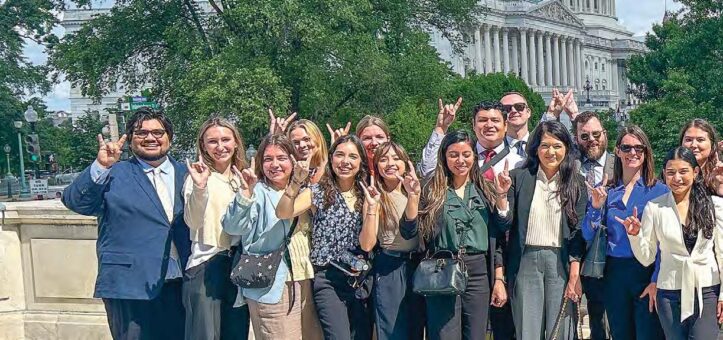 group of students with Hook 'em signs