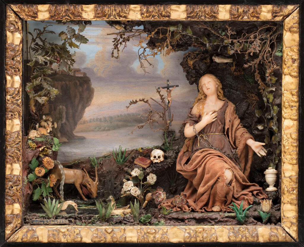 Historic female figure in robes surrounded by objects and a reference to Christ