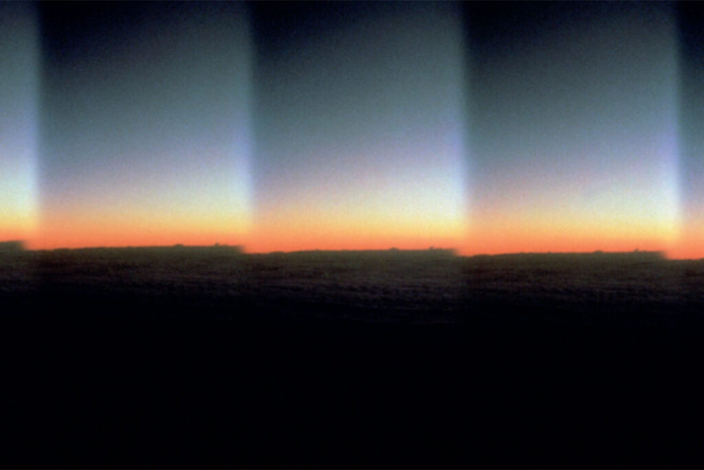 digitally manipulated image showing landscape at dusk repeating horizontally in frame