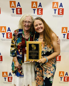 Photo of Roxanne accepting her award at AATE