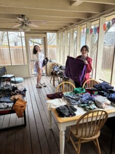 Students looking through donated clothes. 