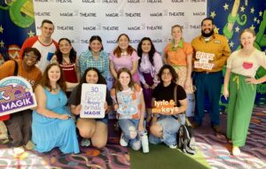 UTeach Theatre Students and cast of Lyric & the Keys in front of a step and repeat.