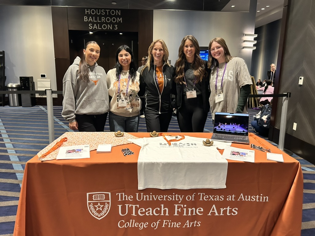 Collegiate Fair on Wednesday, January 8, 2025. Student in front of table with UTeach Fine Arts logo on tablecloth. (L to R) Megan Ramos (Cohort 12), Emily Figueroa (Cohort 11), Tina Curran (UTeach Dance Coordinator), Sarah Johnston (Cohort 11), Hayley Jeansonne (Cohort 11).