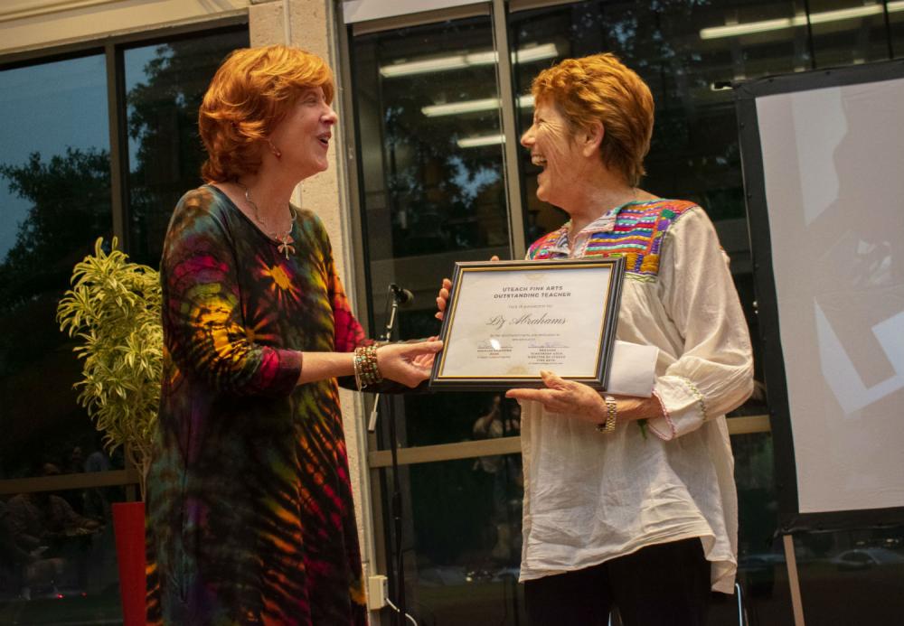 UTeach Visual Arts Associate Professor Christina Bain presents alumna Liz Abrahams (B.F.A., Art Education, 1979) with the inaugural UTeach Fine Arts Outstanding Educator Award on May 3.