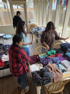 Students looking through donated clothes. 