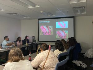 Presenters and Students at resource fair. Presentation on the projector. 