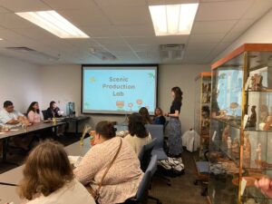 Presenters and Students at resource fair. Presentation on the projector. 