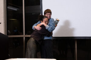 UTFA Music faculty and student hugging after senior gift is given to them.