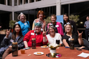 UTFA Art faculty and students sitting at a table at the UTFA Spring Celebration event.