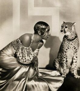 Image of Josephine Baker posing with her pet cheetah